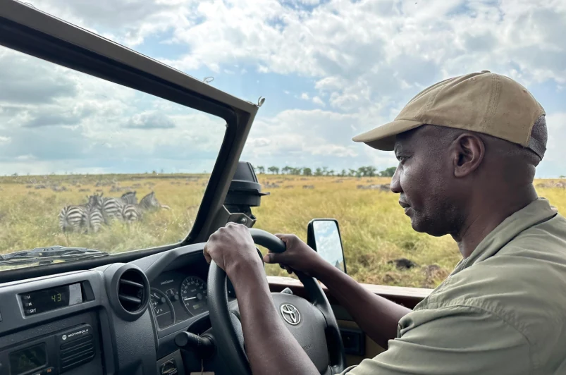 Local driver operating a four-wheel-drive vehicle in an open landscape